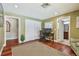 Office featuring hardwood floors, an adjacent bathroom, and a serene view of the outdoors at 16205 Sentry Woods Ct, Odessa, FL 33556