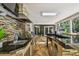 Gourmet outdoor kitchen with stone accents, stainless steel appliances, and counter seating at 16205 Sentry Woods Ct, Odessa, FL 33556