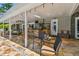 Covered outdoor kitchen area with stone floors, a built-in bar, grill, and seating at 16205 Sentry Woods Ct, Odessa, FL 33556