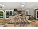 Covered outdoor kitchen featuring granite counters, tile backsplash, stainless appliances, and bar seating at 16205 Sentry Woods Ct, Odessa, FL 33556