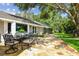 Stone patio with outdoor dining area and access to the spacious backyard at 16205 Sentry Woods Ct, Odessa, FL 33556