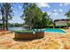 Large stone patio features outdoor seating, and lake views perfect for entertaining at 16205 Sentry Woods Ct, Odessa, FL 33556