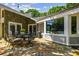 Outdoor patio with elegant dining set and stone exterior with inviting ambiance at 16205 Sentry Woods Ct, Odessa, FL 33556