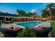 Inviting in-ground pool with comfortable seating area, perfect for enjoying warm weather and outdoor gatherings at 16205 Sentry Woods Ct, Odessa, FL 33556