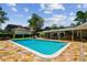 Backyard pool area boasts stone pavers, covered patio and outdoor seating perfect for entertaining at 16205 Sentry Woods Ct, Odessa, FL 33556