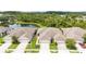 Expansive aerial view of the home's landscaping and surrounding pond, nestled amongst lush trees at 1914 Sassafras Dr, Wesley Chapel, FL 33543