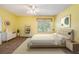 Inviting bedroom with neutral tones, a ceiling fan, and large window allowing natural light at 1914 Sassafras Dr, Wesley Chapel, FL 33543