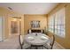 Cozy dining room with natural light, round table, and view to the laundry room at 1914 Sassafras Dr, Wesley Chapel, FL 33543