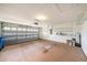 Spacious two-car garage with storage shelving and door at 1914 Sassafras Dr, Wesley Chapel, FL 33543