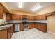 Well-equipped kitchen with stainless steel appliances, granite countertops, and tile backsplash at 1914 Sassafras Dr, Wesley Chapel, FL 33543