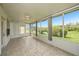 A beautiful sunroom with tiled flooring and sliding glass windows at 1914 Sassafras Dr, Wesley Chapel, FL 33543