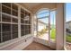 View from the screened lanai, showcasing brick flooring and views of the home's landscaping at 1914 Sassafras Dr, Wesley Chapel, FL 33543