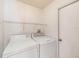A bright laundry room with white washer and dryer at 1914 Sassafras Dr, Wesley Chapel, FL 33543