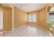 A sunny living room with tile floors and large windows creates a bright and inviting atmosphere at 1914 Sassafras Dr, Wesley Chapel, FL 33543