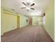 Open concept living room with carpet flooring, a ceiling fan, and views into adjacent rooms at 1914 Sassafras Dr, Wesley Chapel, FL 33543