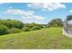 Expansive backyard featuring a large grassy lawn with mature landscaping at 200 Eppinger Dr, Port Charlotte, FL 33953