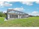 Wide view of the large screened in pool, paved patio, and lush lawn at 200 Eppinger Dr, Port Charlotte, FL 33953