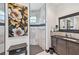 Modern bathroom featuring granite countertop, dark wood cabinets, and tiled shower at 200 Eppinger Dr, Port Charlotte, FL 33953