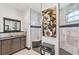 Bright bathroom with granite countertop, dark wood cabinets, and large tiled shower at 200 Eppinger Dr, Port Charlotte, FL 33953