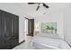 Well-lit bedroom with a queen-size bed, ceiling fan, and tiled floors at 200 Eppinger Dr, Port Charlotte, FL 33953