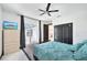 Bright bedroom with ceiling fan, closet, tiled floors, and sliding door to the patio at 200 Eppinger Dr, Port Charlotte, FL 33953