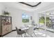 Modern dining area with contemporary furniture, open layout and sliding glass doors that lead to the patio and pool area at 200 Eppinger Dr, Port Charlotte, FL 33953