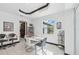 Bright dining area featuring a modern table, stylish chairs, and seamless access to the outdoor patio and pool at 200 Eppinger Dr, Port Charlotte, FL 33953