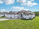 Charming single-story home featuring a lush green lawn, a two-car garage, and an inviting front entryway at 200 Eppinger Dr, Port Charlotte, FL 33953