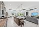 Open kitchen with a large island, stainless steel appliances, and seamless connection to the living and dining areas at 200 Eppinger Dr, Port Charlotte, FL 33953