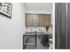A laundry room featuring a dark washer and dryer, overhead cabinets, and a utility sink at 200 Eppinger Dr, Port Charlotte, FL 33953