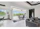 Bright room with sliding glass doors to an outdoor patio and pool, tiled floors, and minimalist decor at 200 Eppinger Dr, Port Charlotte, FL 33953