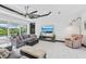 Bright living room features modern furnishings, a large ceiling fan, and sliding glass doors leading to outdoor living at 200 Eppinger Dr, Port Charlotte, FL 33953