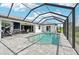 Screened in pool with an outdoor kitchen, dining area, and access to living room at 200 Eppinger Dr, Port Charlotte, FL 33953