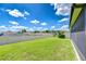 Large backyard features a privacy fence, lush green lawn, and mature landscaping, perfect for outdoor living at 208 English Heritage Pl, Dover, FL 33527