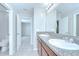 Bright bathroom with double sinks, granite countertops, and tiled floors at 208 English Heritage Pl, Dover, FL 33527