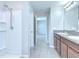 Bathroom featuring tiled floors, a walk-in shower, and a double vanity with granite countertops at 208 English Heritage Pl, Dover, FL 33527