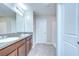 Bathroom features a double vanity with granite countertops and tiled floors at 208 English Heritage Pl, Dover, FL 33527