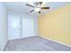 A bright bedroom with carpet, fan, a window, and a double-door closet at 208 English Heritage Pl, Dover, FL 33527