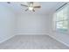 Bedroom featuring tile floors, a ceiling fan, and a window with blinds at 208 English Heritage Pl, Dover, FL 33527