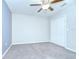 Bright bedroom with neutral carpet, fan, and a double-door closet for ample storage at 208 English Heritage Pl, Dover, FL 33527