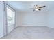 Roomy carpeted bedroom featuring a ceiling fan and a window with views of the outside at 208 English Heritage Pl, Dover, FL 33527