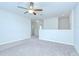 Large bedroom with neutral paint, plush carpet, and a modern ceiling fan at 208 English Heritage Pl, Dover, FL 33527