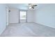 Spacious carpeted bedroom with a ceiling fan and natural light from a window at 208 English Heritage Pl, Dover, FL 33527