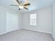 Well-lit bedroom with neutral carpet, fan, a window, and a double-door closet at 208 English Heritage Pl, Dover, FL 33527
