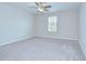 Spacious bedroom with neutral paint, carpet, ceiling fan, and a bright window at 208 English Heritage Pl, Dover, FL 33527