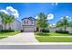 Beautiful two-story home with lush landscaping, a well-manicured lawn, and a spacious driveway at 208 English Heritage Pl, Dover, FL 33527