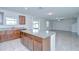 Eat-in kitchen with granite counters, dark cabinets, and open to living room with tile floors at 208 English Heritage Pl, Dover, FL 33527