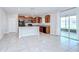 Open concept eat-in kitchen featuring granite counters, dark cabinets and stainless steel appliances at 208 English Heritage Pl, Dover, FL 33527