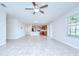Open-concept living space featuring tile floors, kitchen with modern appliances at 208 English Heritage Pl, Dover, FL 33527