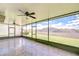 Screened-in patio with tiled floors, ceiling fans, and views of the backyard at 208 English Heritage Pl, Dover, FL 33527